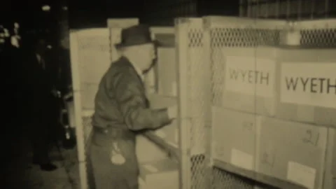 Men transporting Wyeth vaccines boxes and vaccination poster for "Sabin Oral Sun Stock Footage 245779107