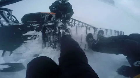 Men try to turn over snowmobile Video stock 102160783