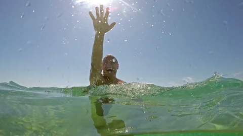 Men trying to catch the camera into the sea, half underwater shot Stock Footage 91586678