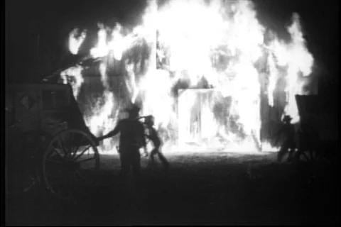 Men trying to extinguish barn fire at night, 1930s Stock Footage 90727785