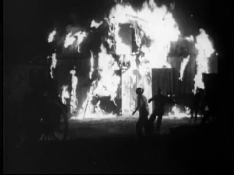 Men trying to extinguish barn fire at night, 1930s Stock Footage 260258507