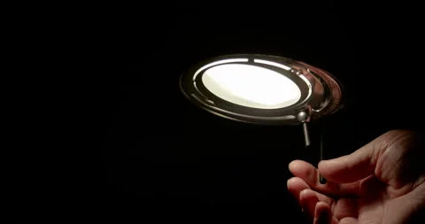 Men turning on lamp / Slow motion Stock Footage 130985019
