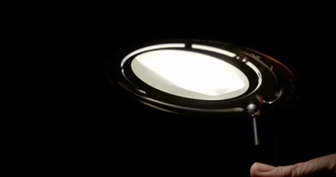 Men turning off lamp / Slow motion Stock Footage 130985064