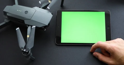 Men Turning On Program On Tablet With Blank Green Screen Connected To Copter Stock-Footage 104592553