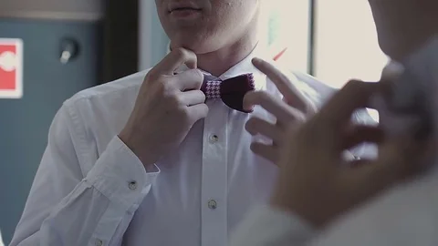 Men tying a bow tie Stock Footage 79611154