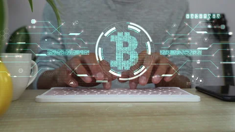 A men typing a computer keyboard for analysis business data and bitcoin sign. Stock Footage 172394181