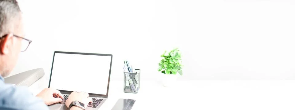 Men typing on a keyboard to use computer network. Laptop blank, white screen Stock Photos