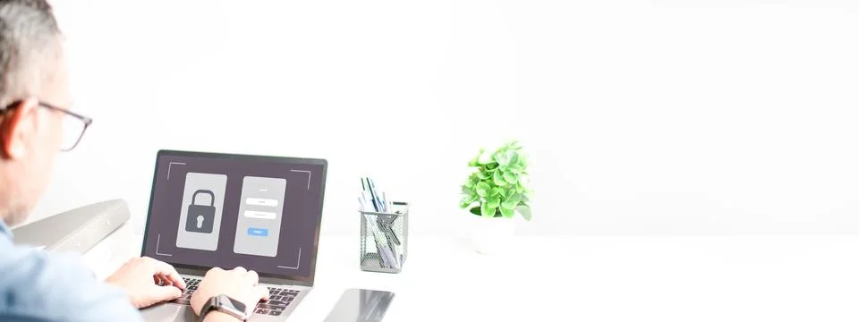 Men typing on a keyboard to use computer network. Laptop screen showing Stock Photos