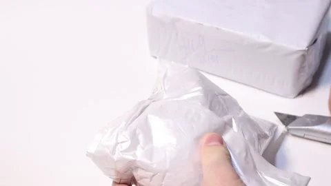 Men unboxing delivered cardboard parcel with device Stock Footage 147937553