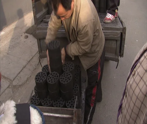 Men unloading coal ash bricks from truck and stacking them on ground Stock Footage 86745403