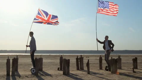 Men with US and UK flags in their hands. Stockbeeldmateriaal 137947086