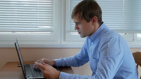 Men use a computer for online purchases with a credit card. 4k, Stock Footage 81544385