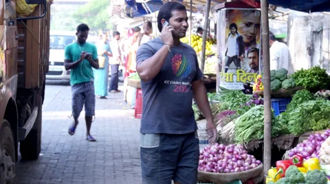 Men Using Cell Phones in Indian Marketplace Stock Footage 38111079