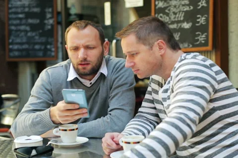 Men using cellphone and sitting outside the cafe 스톡 동영상 36833227