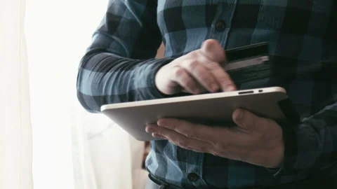 Men using tablet for online banking Stock Footage 100536047