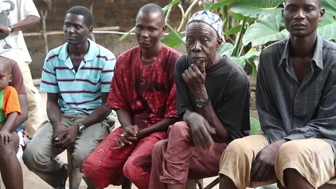 Men in village having a debate about potable water- Guinea Africa Vidéo 76340787