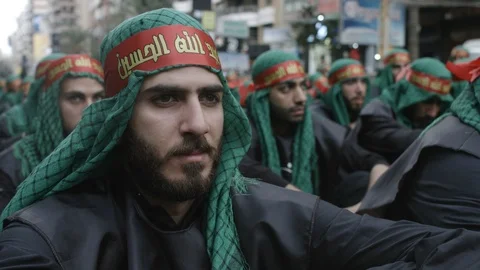 Men wait the begining of Ashura's procession organized by Hezbollah Stock Footage 119949271