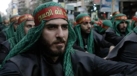 Men wait the begining of Ashura's procession organized by Hezbollah Stock Photos