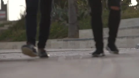 Men walk on a sidewalk Stock-Footage 147729890
