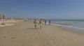 Men walking on the beach and girls standing near the water, Porto 4k or 4k+ Resolution