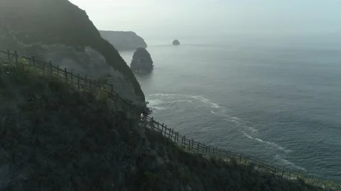 Men walking down the stairs to the beach on the island 動画素材 154503014