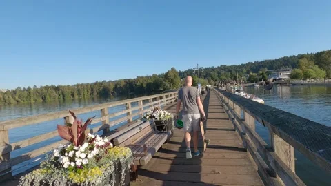 Men walking with longboard Stock Footage