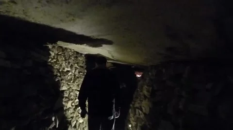Men Walking Thru Catacomb Stone Tunnel Stock-Footage 43728045