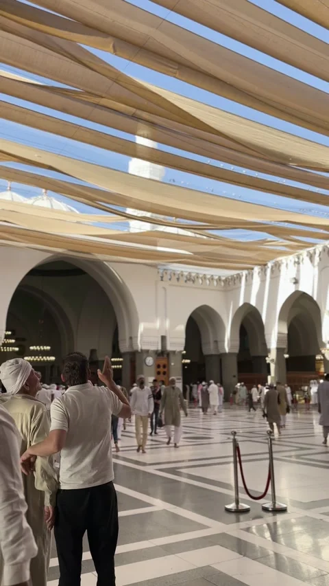 Men Walking Under Canopy Shades in Masjid Quba Stock Footage 344060271