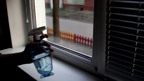 Men washes windows in home. Cleaning window with a wash spray and a duster. Stock Footage 127282086