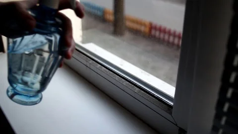 Men washes windows in home. Cleaning window with a wash spray and a duster. Stock Footage 127282693