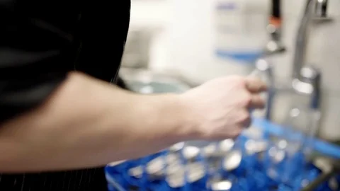 Men is washing and cleaning dishes in a restaurant Stock Footage