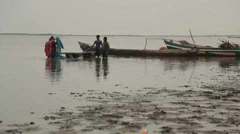 Men washing the fish net in the ocean water in Sri Lanka Stock Footage 49365717