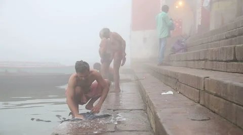 Men washing laundry and preparing to bath at shore of Ganges river, closeup. Stock Footage 50352089