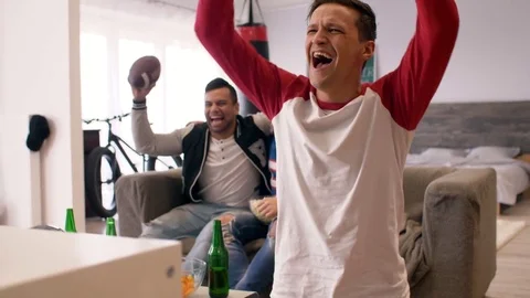 Men watching american football competition and cheering Stock Footage