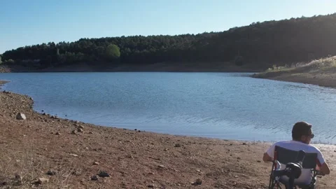 Men watching the lake view after the bike tour Video stock 294135997