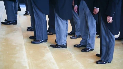 Men wearing the same tail coats at an official ceremony. Video stock 120453022