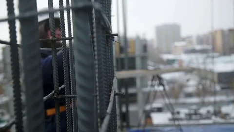 Men weave armature with a working tool Stock Footage 82137361