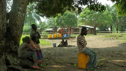 Men while children take water from a well Stock Footage 107141203