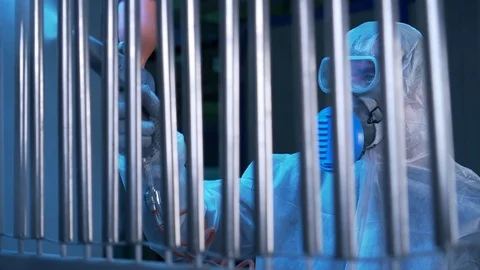 Men in white protective masks treated with a chemical solution metal structure Stock Footage 117985535