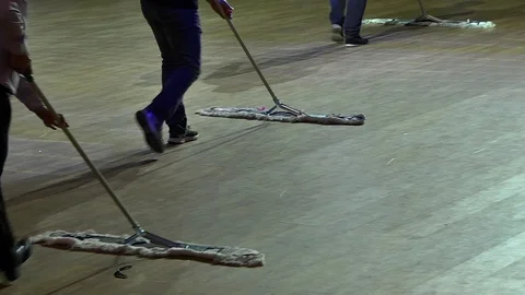 Men who do cleaning, wipe the floor mop, one bends to take something away Stock Footage 88433280