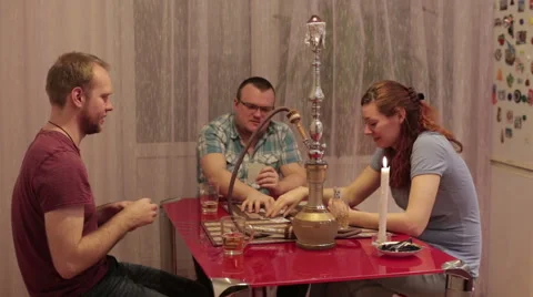 Men with woman smoking shisha and drinking alcohol Stock Footage 59583715