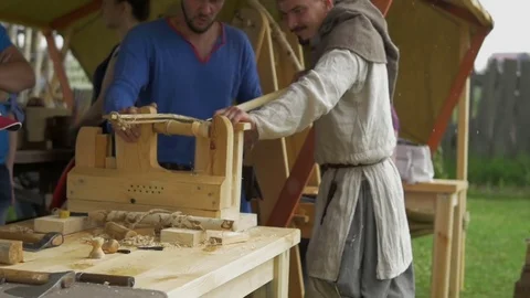 Men work behind a sharpener Stock Footage 82403369