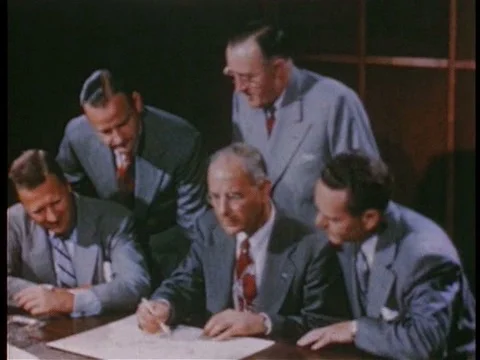 Men work on a design for a new car in the 1940s. Stock-Footage 75294333