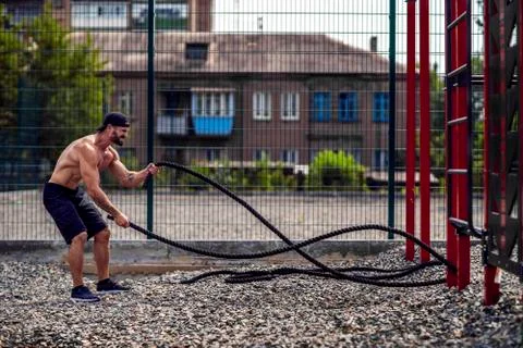 Men work hard with rope, functional training Stock Photos