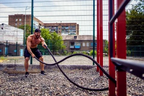 Men work hard with rope, functional training Stock Photos