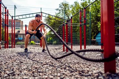 Men work hard with rope, functional training 库存照片