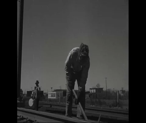 Men work with the help of pickaxes on railroad tracks - 1930 Stock Footage 101715087