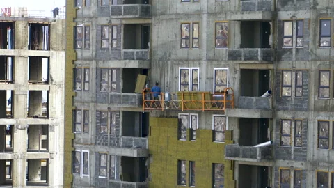 Men work with insulation at a construction site 4K Stock-Footage 154004178