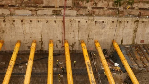 Men at work for large construction of large complex buildings under the rain Stock Footage 123890518