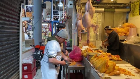 Men work in a meat stand stall of San Juan Market, Mexico City, 4K Stock Footage 306225980